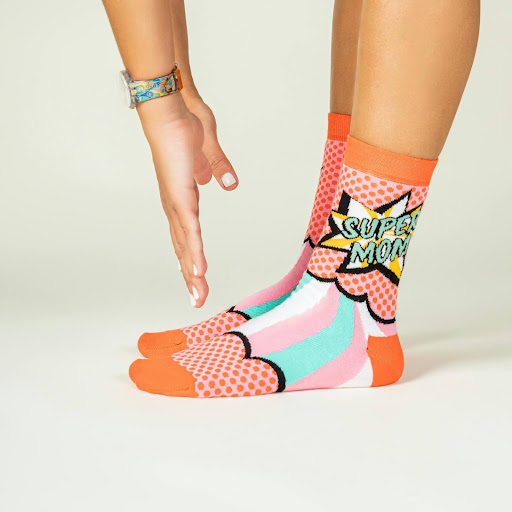 Woman bending over to touch her toes wearing brightly colored socks