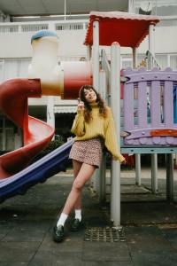 Stylish woman standing at a playground